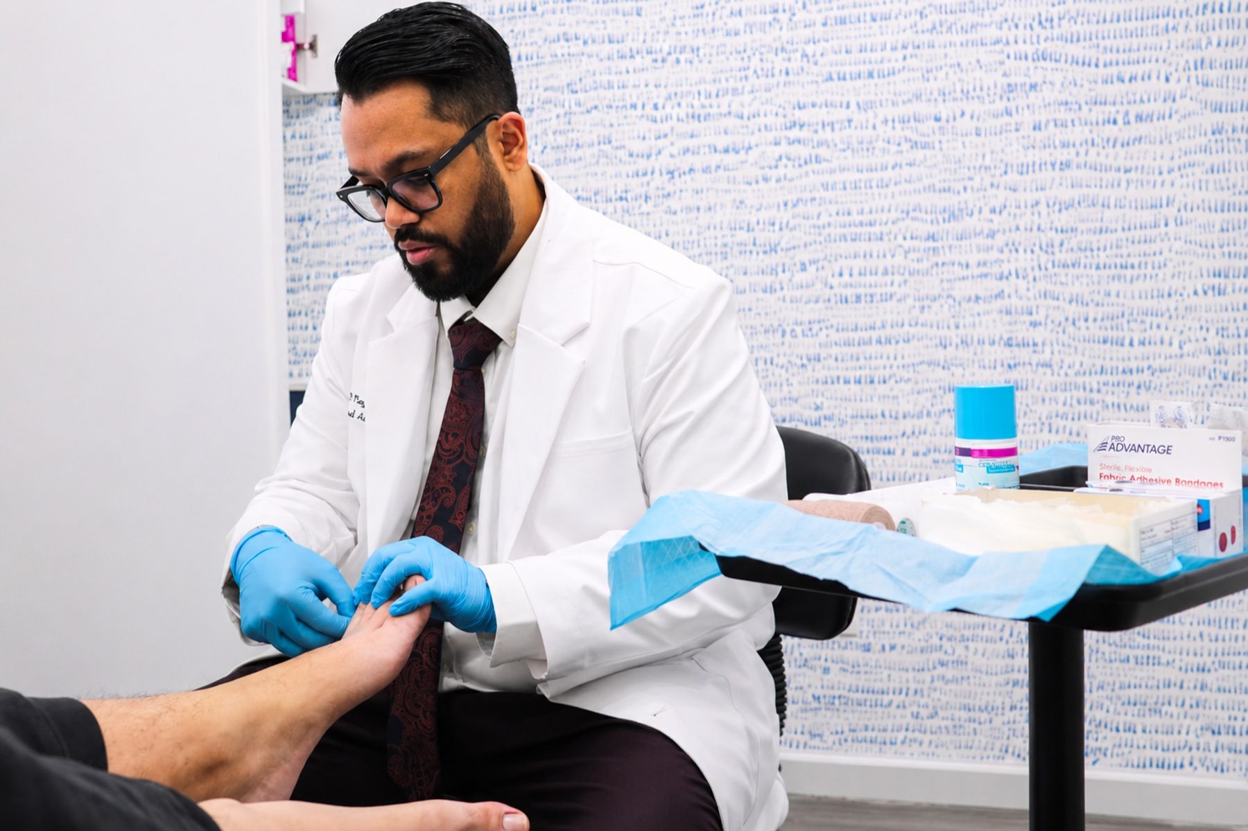 Dr. Nayeem examining a patient's foot