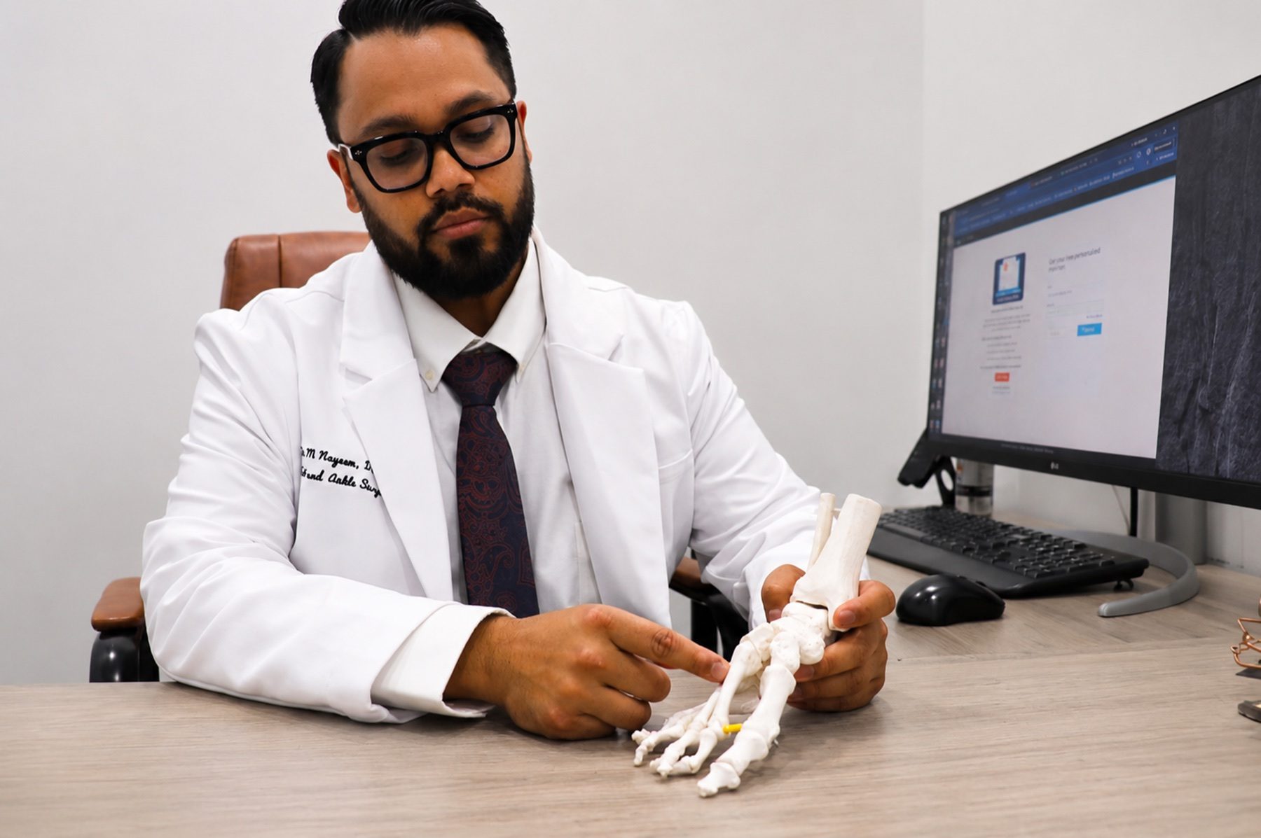 Dr. Nayeem explaining foot anatomy during a patient consultation